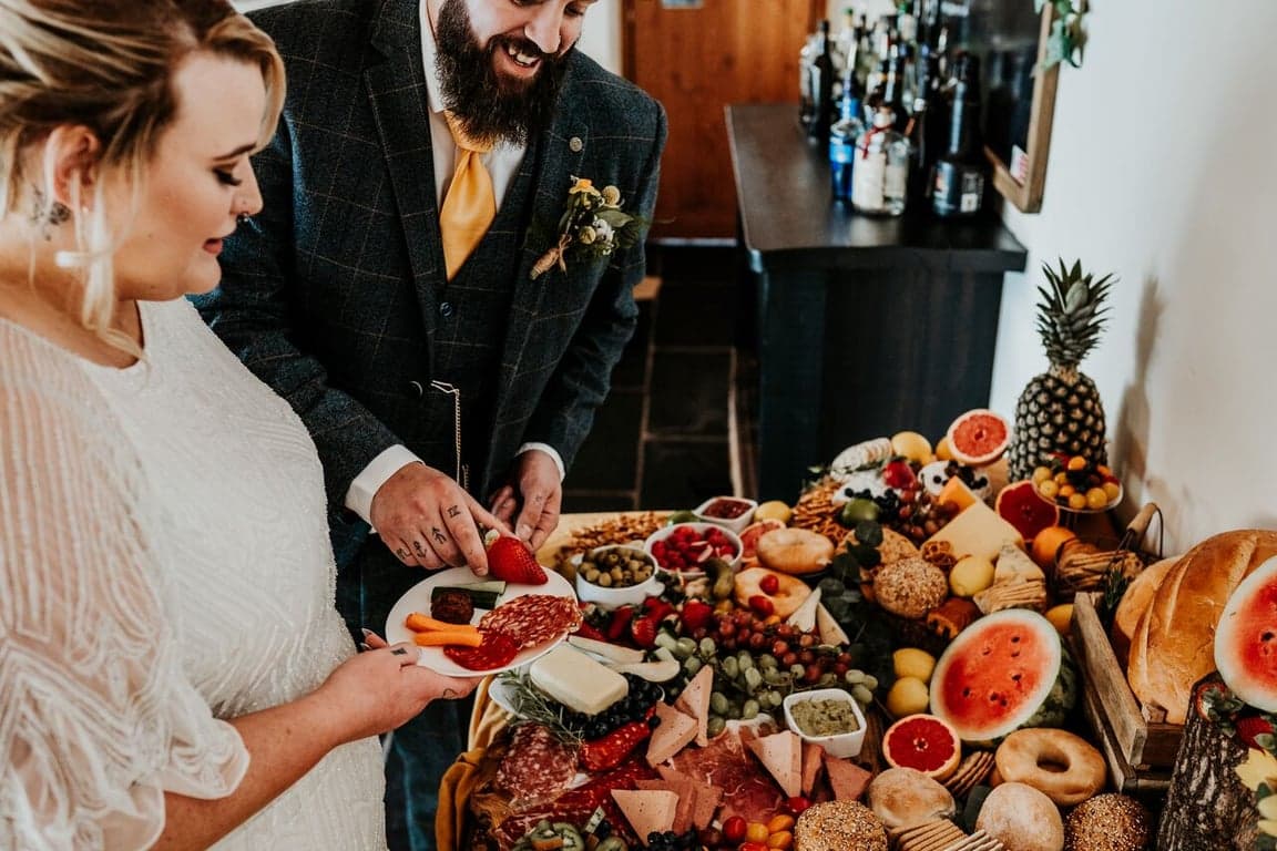 A married couple eating from a grazing board