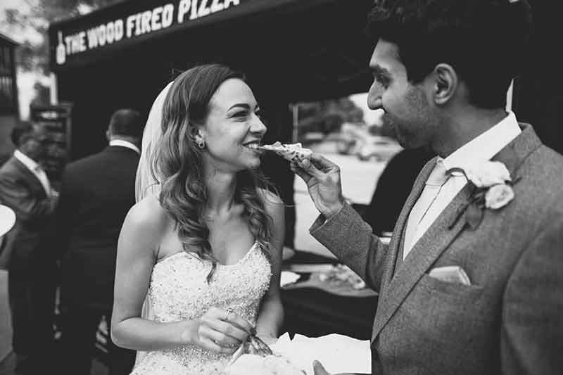 Bride and groom eating pizza